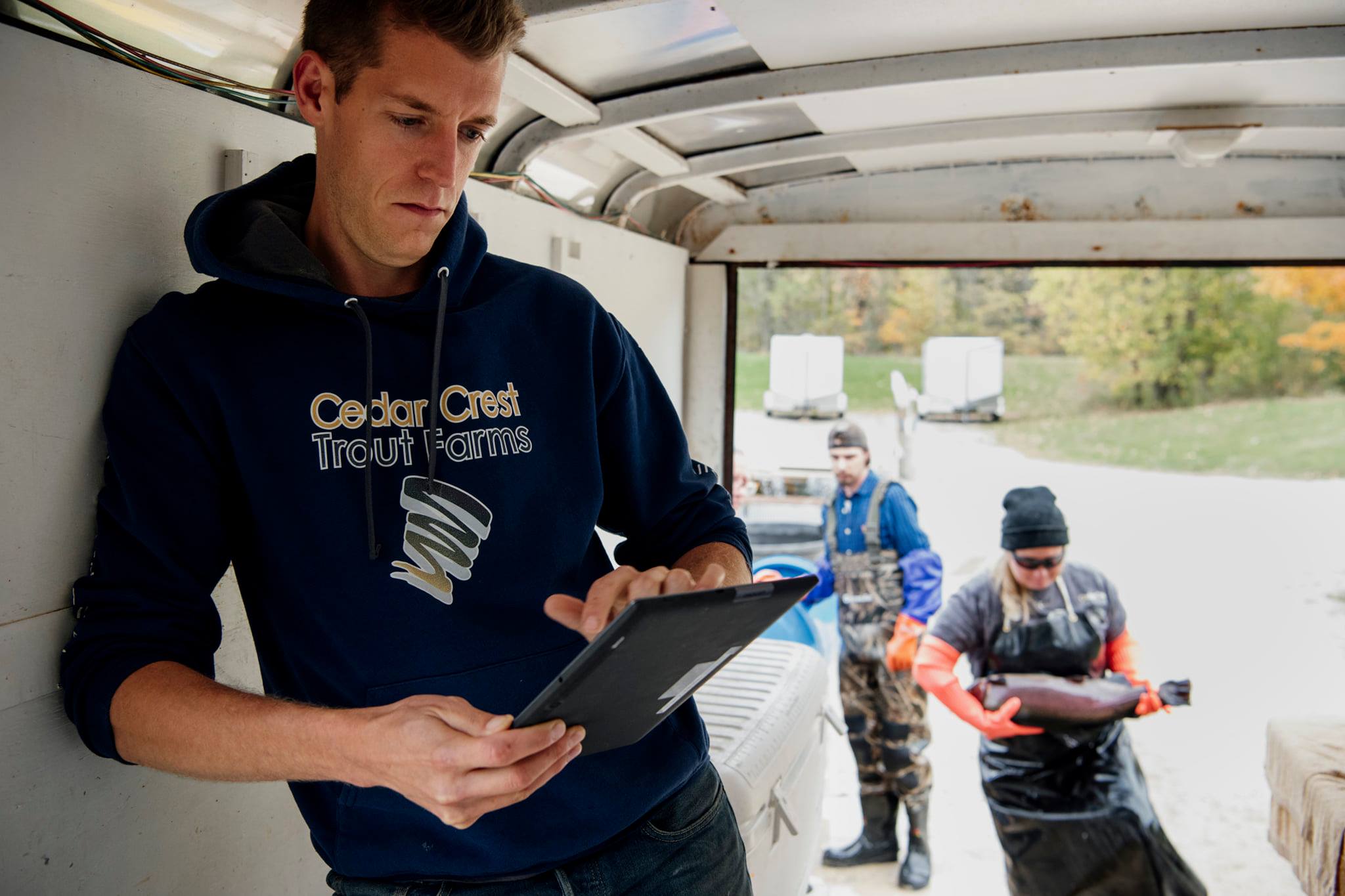 Man with tablet on fish farm